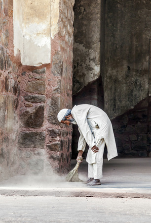 DELHI, INDIA - NOV 11, 2011: workers at Humayun's Tomb cleans the yard in Delhi, India. They also get alms by religious people. The tomb was built by Hamida Banu Begun in 1565-72 A.D..のeditorial素材