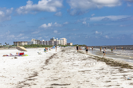 FORT MYERS, USA - JULY 27, 2013: Unknown people on a beach in Fort Myers, USA. Fort Myers first became a nationally known winter resort with the building of the Royal Palm Hotel in 1898.のeditorial素材