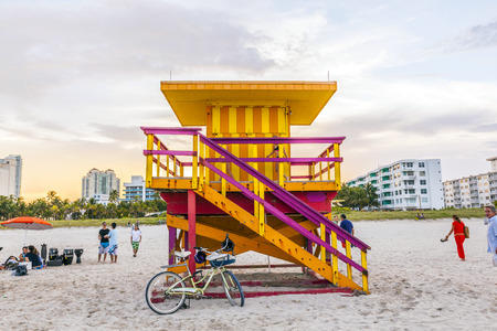 MIAMI, USA - JULY 28, 2013: people enjoy the beach in the evening in Miami, USA. South beach is famous for its wooden lifeguard towers which are designed in Art deco style.のeditorial素材