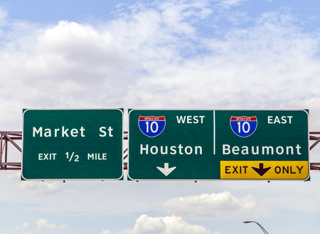 street signs at the interstate in Texas under blue skyの写真素材