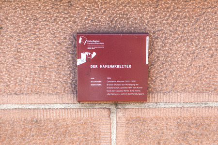 FRANKFURT, GERMANY - MARCH 2, 2013:   plate of statue der Hafenarbeiter at the bridge in Frankfurt, Germany. The statue was a gift of the company Cassella and build by artist Constantin Meunier in 1899.のeditorial素材