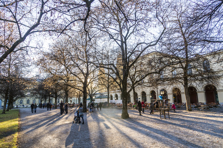 MUNICH, GERMANY - DECEMBER 27, 2013: Unidentified people enjoy the chinook wind at a rest place in the Hofgarten, a famous public park in Munich, Bavaria, Germany.のeditorial素材