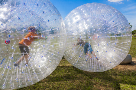 children have a lot of fun in the Zorbing Ballの写真素材