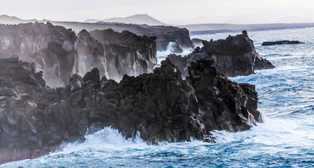 rough coast with huige waves in Lanzaroteの写真素材