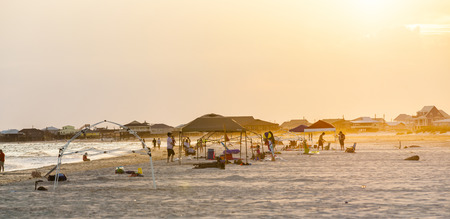 DAUPHIN ISLAND, USA - JULY 17, 2013: people enjoy the beautiful beach in late afternoon  at Dauphin Island, USA.のeditorial素材