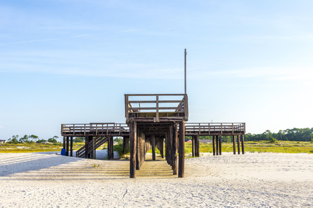 wooden pier at Dauphin Island in afternoon sunの写真素材