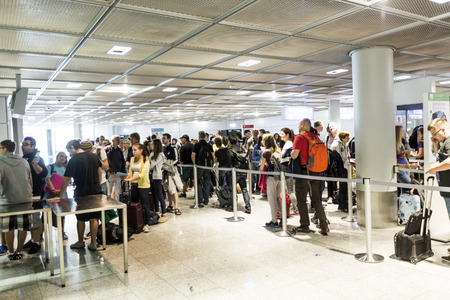 FRANKFURT, GERMANY- AUGUST 16, 2014: passengers at the departure hall. With 38 million passengers per year it is one of the most important airport in Europe.のeditorial素材