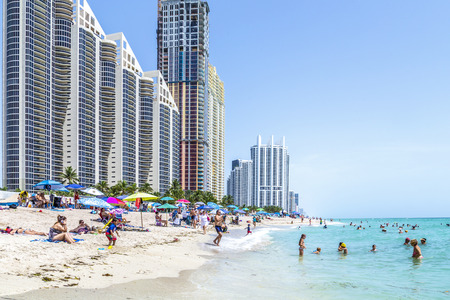 SUNNY ISLES BEACH, USA - AUG 2014: people at Jade beach and Jade Ocean condominiums. Jade Beach and Ocean were completed in 2009 with a elevation of 549 feet located at 170th Street in Sunny Isles Beach. USA.のeditorial素材