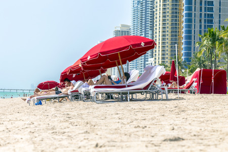 SUNNY ISLES BEACH, USA - AUG  17, 2014: people enjoy Jade beach in Sunny Isles Beach, USA. Jade Beach and Ocean were completed in 2009 with a elevation of 549 feet located at 170th Street.のeditorial素材