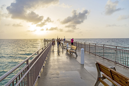 SUNNY ISLES BEACH, USA - AUG 17, 2014: people catch fishes at  the pier in Sunny Isles Beach, USA. In 1936, Milwaukee malt magnate Kurtis built the Sunny Isles pier.のeditorial素材