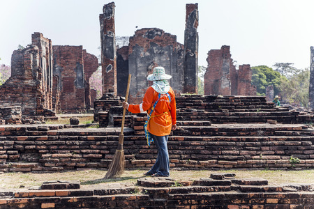 AYUTTHAYA, THAILAND - DEC 24, 2009: worker at temple area in Ayutthaya, Thailand. The Ayutthaya historical park covers the ruins of the old city of Ayutthaya, Thailand.のeditorial素材