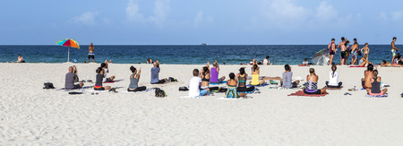 MIAMI, USA - AUGUST 18, 2014: People at the sea side in Miami, USA. Miami Beach is a popular destination among tourists, spiking during the winter time.のeditorial素材