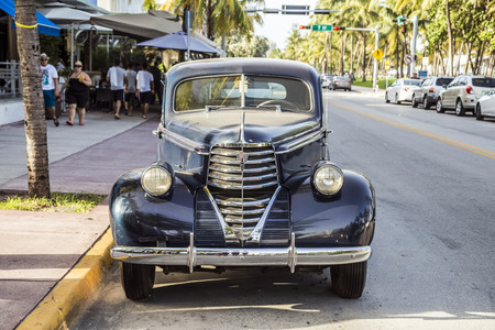 MIAMI, USA - AUG 19, 2014: classic Oldsmobile parks in front of the Hotel Park Central in Miami, USA. Built in 1937, The Park Central is known as The Blue Jewel of Ocean Drive.のeditorial素材