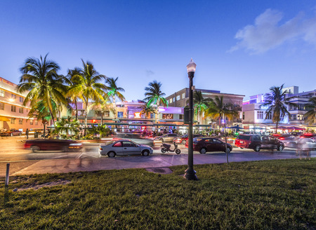 MIAMI, USA - AUG 23, 2014: Palm trees and art deco hotels at Ocean Drive by night. The road is the main thoroughfare through South Beach in Miami, USA.のeditorial素材