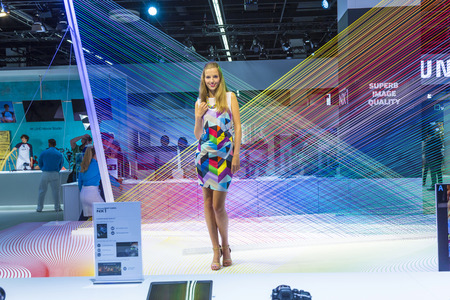 PHOTOKINA, COLOGNE - SEPTEMBER 19, 2014: models pose for visitors at  Photokina in Cologne, Germany. They pose for free shootings for visitors to test the new cameras.のeditorial素材