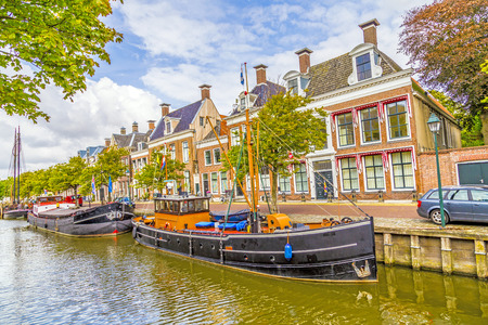 old boats in a canal in Harlingenの写真素材