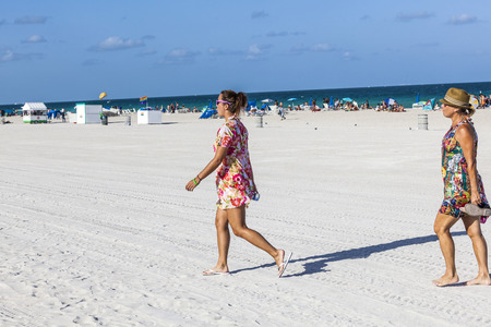 MIAMI, USA - AUG 23, 2014: Beach scene at end of day, kiosks close up, people leave, beach cleaners arrive  at Miami, USA. A daily scene on South Beach when preparation for next day starts.のeditorial素材