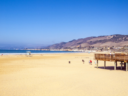 PISMO BEACH, USA - OCT 8, 2014: people enjoy view of the old pier in Pismo Beach, USA. The first pier in Pismo Beach was built in 1882.のeditorial素材
