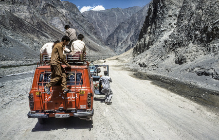 GILGIT, PAKISTAN - JUNE 30, 1987: people on a car stop because of a landslide in Gilgit, Pakistan. The Karakoram Highway is the only street to china and often interrupted by landslides.のeditorial素材