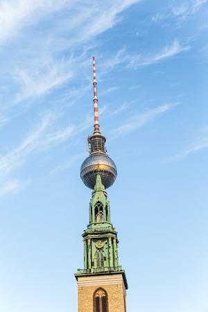 Fernsegtower Alex in Berlin with St. Marys church under blue skyのeditorial素材