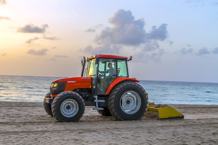 SUNNY ISLES BEACH, USA - AUG 17, 2014: man prepares the beach early morning in Sunny Isles Beach,...