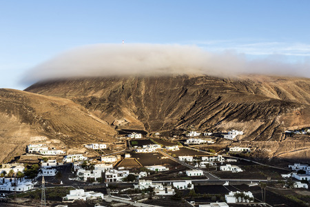 sunrise in the mountains in Femes, Lanzarote with clouds on top of volcanoの写真素材