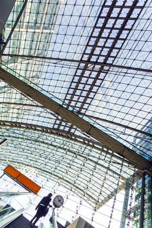 BERLIN, GERMANY - NOV 27, 2014: People inside the Berlin Central train station in Berlin, Germany. It is the is the main railway station in Berlin with a surface area of 85x120 mt.のeditorial素材