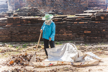 AYUTTHAYA, THAILAND - DEC 24, 2009: worker at temple area in Ayutthaya, Thailand. The Ayutthaya historical park covers the ruins of the old city of Ayutthaya, Thailand.のeditorial素材