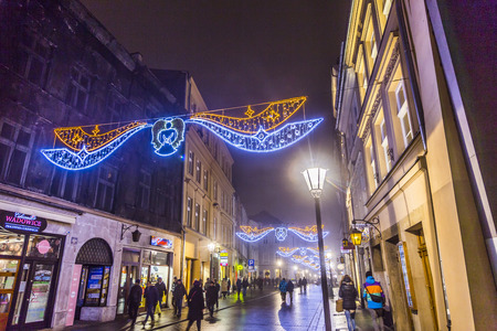 KRAKOW, POLAND - DECEMBER 5, 2014: City center by night: people at Rynek Glowny square druring christmas fair, Krakow, Poland.のeditorial素材