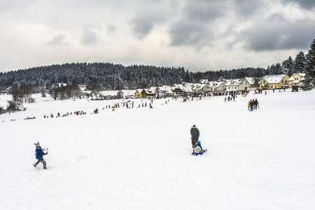KOENIGSTEIN, GERMANY - MARCH 23, 2008: families enjoy the snow in Koenigstein, Germany. The winter season in the Taunus hills are very short and natural covered hills with snow are seldom.のeditorial素材