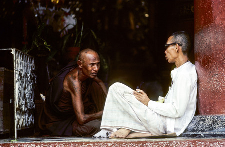 RANGOON, MYANMAR - JULY 7, 1984: monks are diskussing in the shwegadon Pagoda in Rangoon, Myanmar. The discussion between monks is a very inportant religious exercise.のeditorial素材