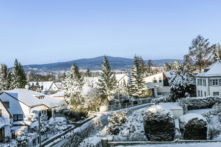 snow coverede houses and mountains in Schwalbach, Germanyの写真素材