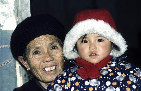 GUEILLIN, CHINA - DEC 30, 1985: proud grandmother poses with her Grandchild in Gueillin, China. The one family policy is obligatory for chinese people.のeditorial素材