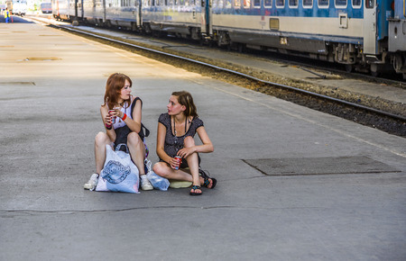 BUDAPEST, HUNGARY - AUGUST 4:  young teenage girls wait for the train at platform of famous West Train Station on August 4, 2008 in Budapest, Hungary. The Station was constructed by Gustafe Eiffel.のeditorial素材
