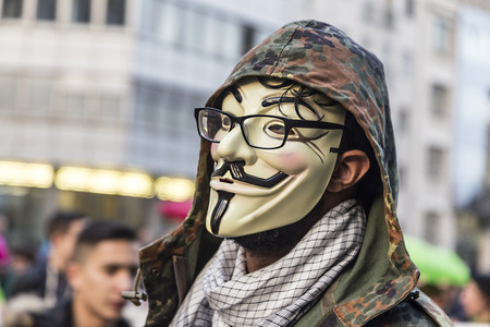 FRANKFURT, GERMANY - MAR 18, 2015: people demonstrate against EZB and Capitalism in Frankfurt, Germany. They wear the occupy mask as symbolのeditorial素材