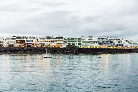 PLAYA BLANCA, SPAIN - NOV 19, 2014: scenic seaview of promenade by night of Playa Blanca, Spain. Playa Blanca became a tourist village since 1980 when a lot of hotels and appartmens were built.のeditorial素材