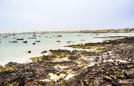 view to scenic  harbor village Corralejo in Fuerteventura with boats