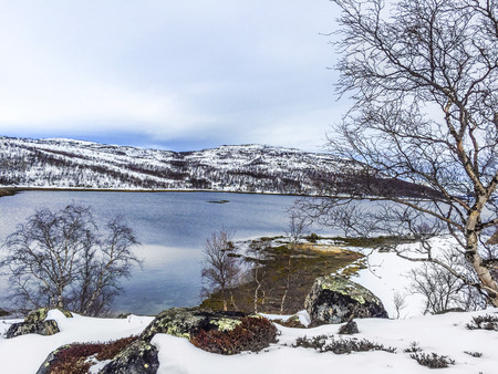 landscape in Norway under snow with icy lakeの写真素材