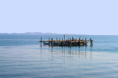 fishing net at an artifical bamboo island in the oceanのeditorial素材