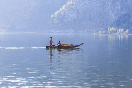 HALLSTATT, AUSTRIA - APR 22, 2015: boat taxi at the Hallstein lake in early morning in Hallstatt, Austria. Hallstatt lake is the main attraction in the Salzkammergut.のeditorial素材