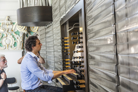 HEIDELBERG, GERMANY JULY 6, 2013: People watch the organ player in the Jesuiten church in Heidelberg, Germany. The church was built between 1712 and 1759.のeditorial素材