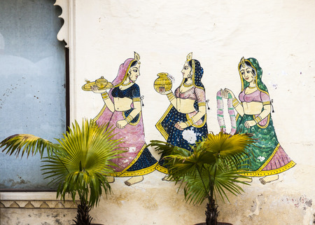 UDAIPUR, INDIA - OCT 21, 2012: famous wall paintings shows women carrying parfumes,water and  necklaces in ancient times   in Udaipur, India.のeditorial素材
