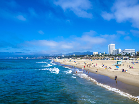 LOS ANGELES, USA - SEP 23, 2014: Many people sunbath on the sand beach and swim in the ocean in Santa Monica Beach, Los Angeles, CA, USAのeditorial素材