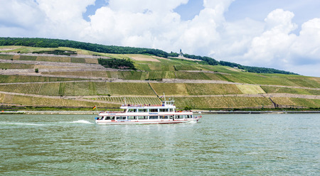 BINGEN, GERMANY - MAY 24, 2015: passenger ferry cruises with passengers at river Rhine in Bingen, Germany. The lovely rhine valley is a world heritage site.のeditorial素材