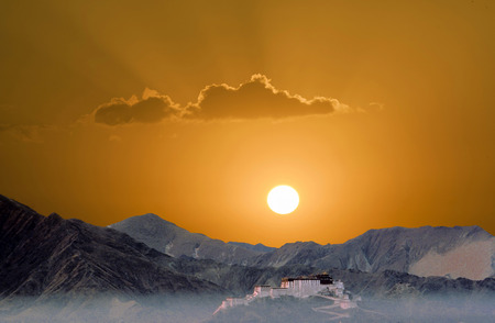 potala in Lhasa in sunset with mountainsの写真素材