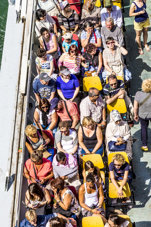 PARIS, FRANCE - JUNE 13, 2015: people enjoy the boat trip on River Seine in Paris, France.  Some 3.5 million passengers per year discover  Paris by a Seine boat trip.のeditorial素材