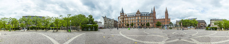 WIESBADEN, GERMANY - JUNE 21, 2015: Town hall Wiesbaden, in the background a steeple of the Marktkirche in Wiesbaden, Germany.のeditorial素材