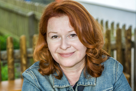 portrait of attractive red hair woman in the garden