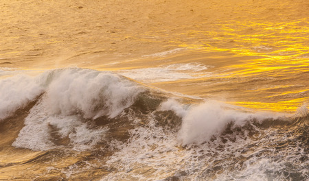 beautiful waves at the beach in sunsetの写真素材