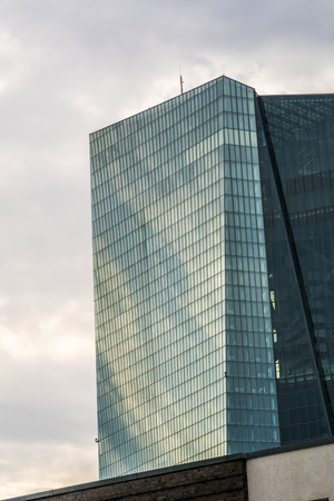 FRANKFURT, GERMANY - JULY 17, 2015: Short time after opening of new headquarters of European Central Bank in Frankfurt, Germany. Dark cloud over building.のeditorial素材